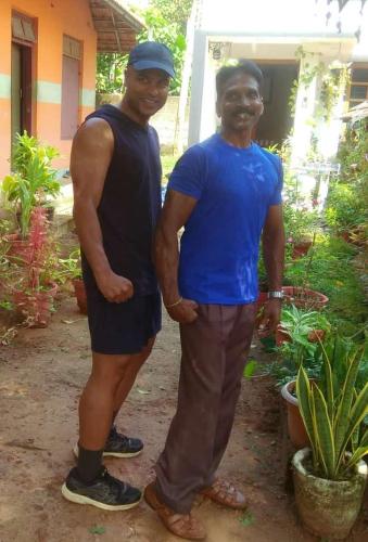 a man and a woman standing in front of a house at CLIFF HEAVEN in Varkala