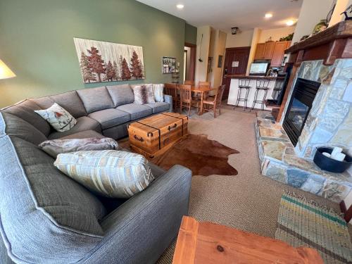 a living room with a couch and a fireplace at Snow Creek Lodge by Fernie Central Reservations in Fernie