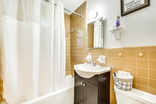 a bathroom with a sink and a shower curtain at Atlanta Vacation Rental Less Than 10 Mi to Downtown! in Atlanta