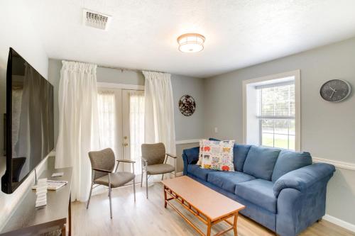 a living room with a blue couch and chairs at Cozy Shenandoah Home Less Than 2 Mi to The Woodlands Mall! in The Woodlands