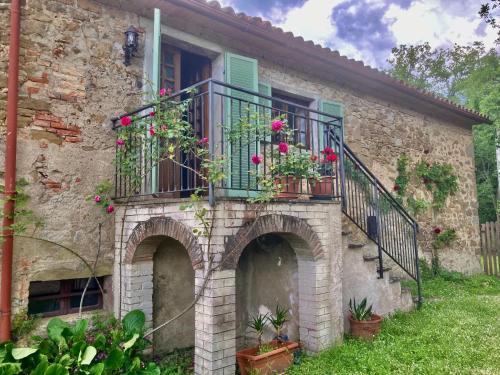 a building with a balcony with flowers on it at Bargi in Lugnano