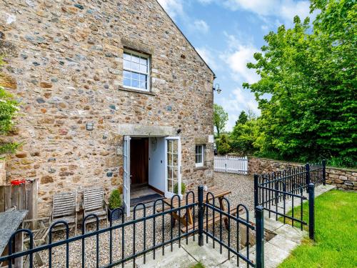 a brick house with a gate in front of it at Warth House - Uk44209 in Ingleton 