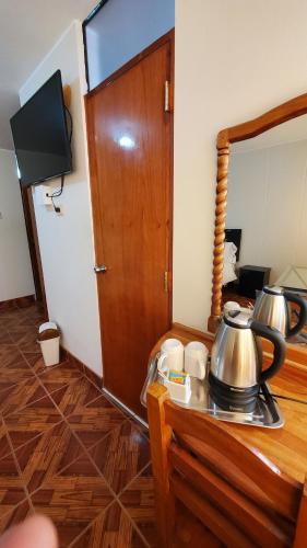 a room with a table with a tea kettle on it at Hotel Wanka Palace in Huancayo