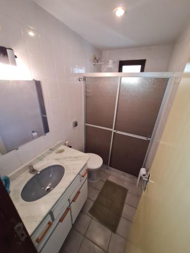 a bathroom with a sink and a shower and a toilet at Vista p Mar Apt. Centro Meaípe in Guarapari