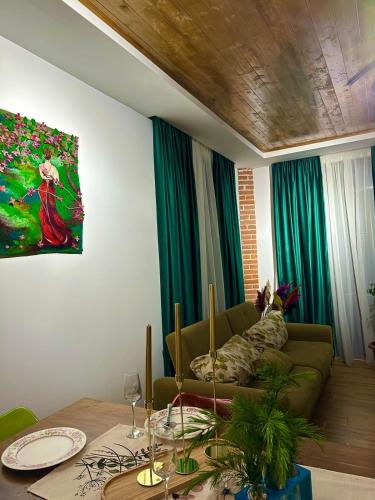 a living room with a couch and a table at WoodStar/ტყის ვარსკვლავი in Ambrolauri