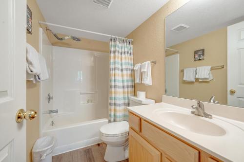 a bathroom with a sink and a toilet and a shower at Charming Walnut Hills Condo in Flagstaff
