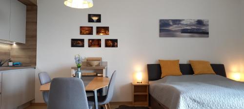 a bedroom with a bed and a desk and a table at Dvě Zátoky Kovářov Studio in Hruštice