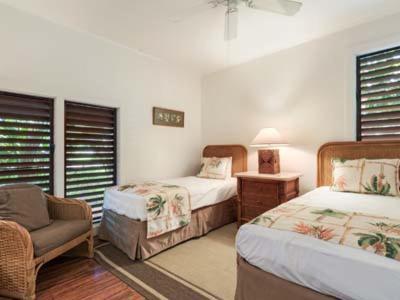a bedroom with two beds and a chair and a couch at Kiahuna Plantation Resort Kauai by OUTRIGGER in Koloa