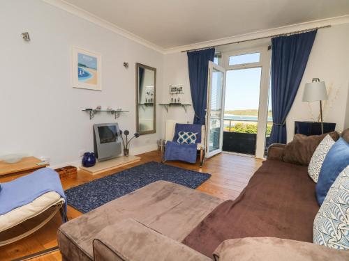 a living room with a couch and a tv at Tides in Padstow