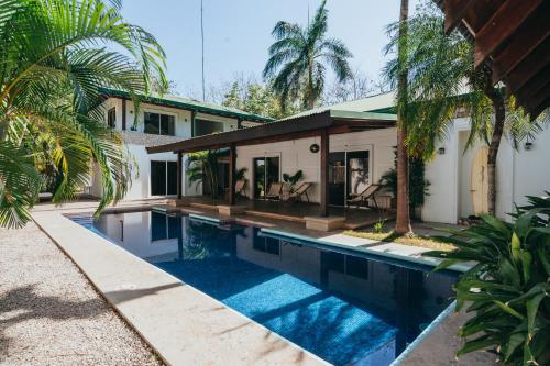 a swimming pool in front of a house at Dream Surf House Avellana in Playa Avellana