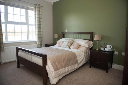 a bedroom with a large bed and a window at Dunagree Bed & Breakfast in Greencastle
