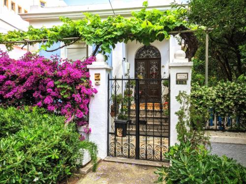 a gate in front of a house with flowers at House with garden in city of Rhodes in Rhodes Town
