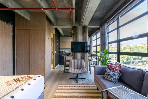 a living room with a couch and a table at Factory Lofts Hotel in Medellín
