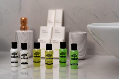 a group of four bottles of hair products on a counter at Aerenia Luxury Suites in Karterados