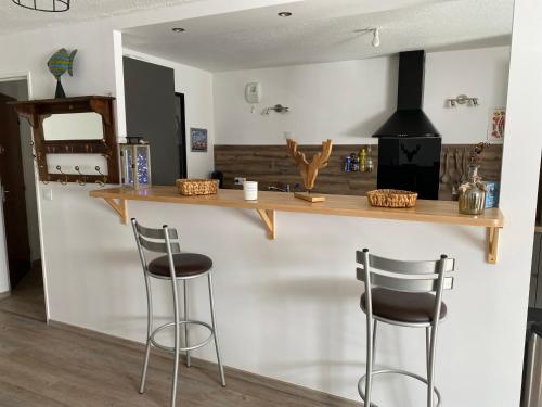 a kitchen with two bar stools and a counter at Cool Montagne in Briançon