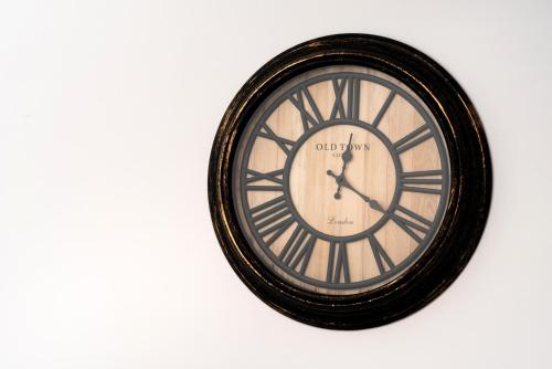 a black and white clock on a wall at Aerenia Luxury Suites in Karterados