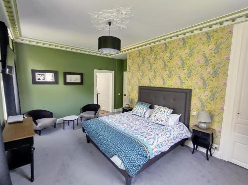 um quarto com uma cama e paredes verdes em Maison Grandsire Chambres D'Hôtes em Saint-Léonard