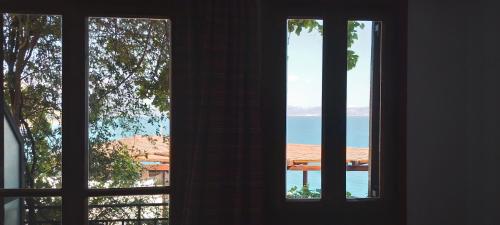 two windows in a room looking out at the ocean at Loggia Two in Agia Galini