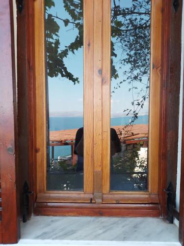 a glass door with a view of the ocean at Loggia Two in Agia Galini