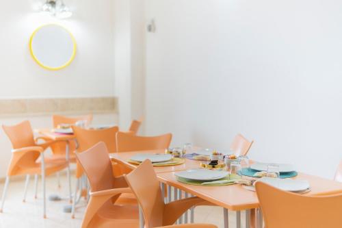 a dining room with tables and chairs and a mirror at Tra I Monti in Tramonti