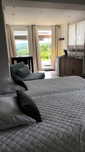 a bedroom with a large bed with pillows on it at studio in Arnos
