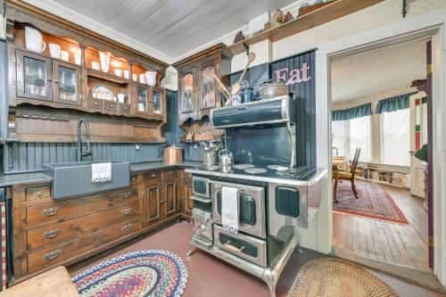 a kitchen with an old fashioned stove and cabinets at 6 Mi to Lake George Adirondack Home with Game Room in Warrensburg