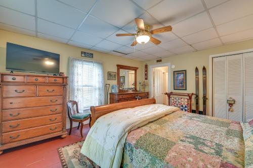 a bedroom with a bed and a ceiling fan at 6 Mi to Lake George Adirondack Home with Game Room in Warrensburg