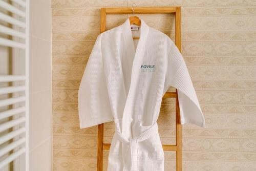 a white robe hanging on a wooden rack at Großzügiges Appartement direkt am Meer mit eigenem Pool - Povile Suites in Novi Vinodolski