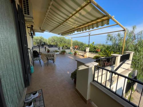a patio with awning and a table and chairs at Home with amazing view in Monte SantʼAngelo