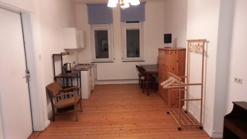 sala de estar con mesa, sillas y escritorio en Double Room with a Kitchen and a Shared Bathroom, en Bremen