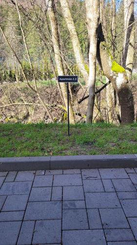 a street sign on the side of a sidewalk at Apartmán Nicole in Tale
