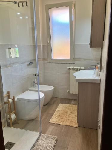 a bathroom with a shower and a toilet and a sink at La casa dell'Asparago in Messina