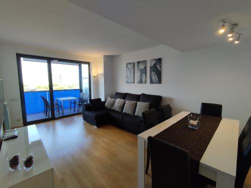 a living room with a couch and a table at Apartment Airport Barcelona Premium in Viladecáns