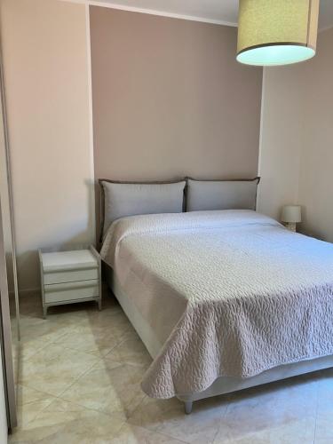 a bedroom with a bed with a white comforter at La casa dell'Asparago in Messina