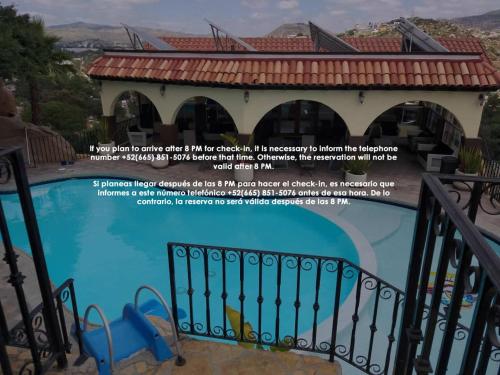 a picture of a house with a swimming pool at Short Stay Tecate Hotel Boutique in Tecate