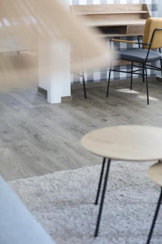 a table and chairs in a room with wooden floors at Le Petit Boutique Hotel in Santander