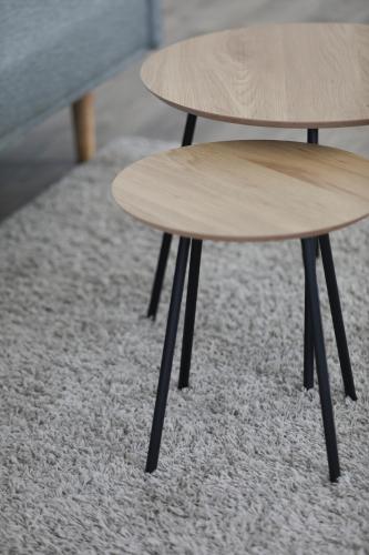 a table and stool sitting on a carpet at Le Petit Boutique Hotel in Santander