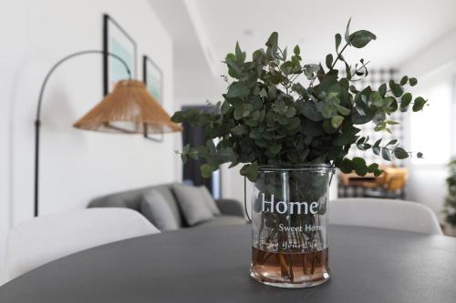 a vase with a plant sitting on a table at Le Petit Boutique Hotel in Santander