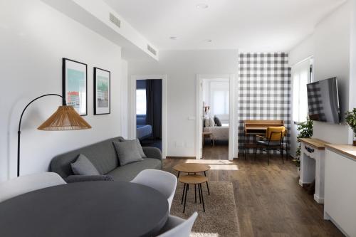a living room with a couch and a table at Le Petit Boutique Hotel in Santander