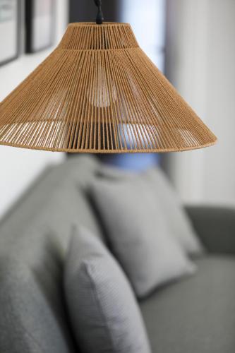 a lamp on top of a couch with a pillow at Le Petit Boutique Hotel in Santander