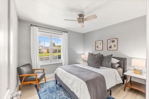 a bedroom with a bed and a chair and a window at Marsh Front Birders Paradise Close to Beaches and Downtown in Saint Augustine