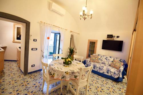 a living room with a table and a couch at Casa De Rosa in Atrani