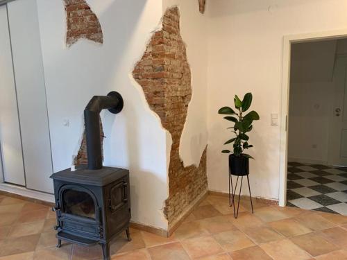 a fireplace in a living room with a stove at Kaptainshuus Apartment B in Leer