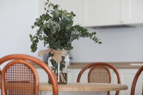 a vase of flowers sitting on a table with chairs at Le Petit Boutique Hotel in Santander