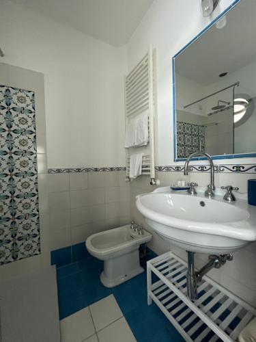 a bathroom with a sink and a toilet at Giuliana's View in Ravello