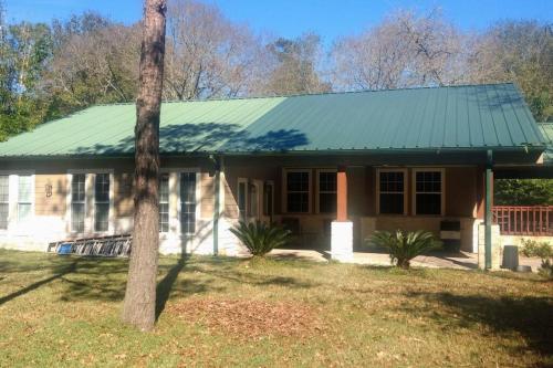 a small house with a green roof at West Wing at the Manor in Montgomery