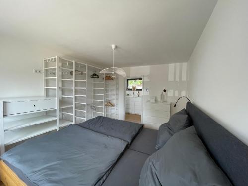 a bedroom with a bed and white shelves at Mit gutem Gefühl ferienwohnen 