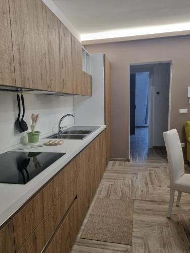 a kitchen with wooden cabinets and a sink at Casa Teresa in Tricase