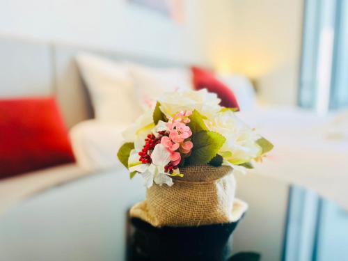 a vase filled with flowers sitting on a table at Edge Central Pattaya Vip Condo in Pattaya Central