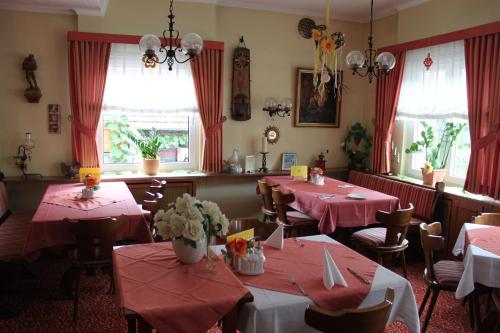 a restaurant with tables and chairs with pink tablecloths at Gasthof Jäger in Heppenheim an der Bergstrasse